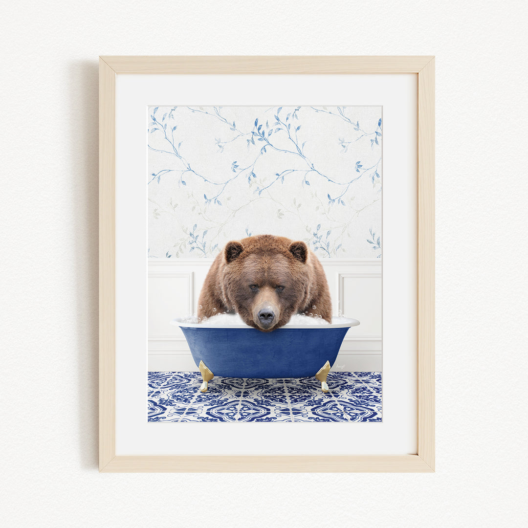 A brown bear is sitting in a blue bathtub, surrounded by a blue and white patterned rug and a floral wallpaper background.