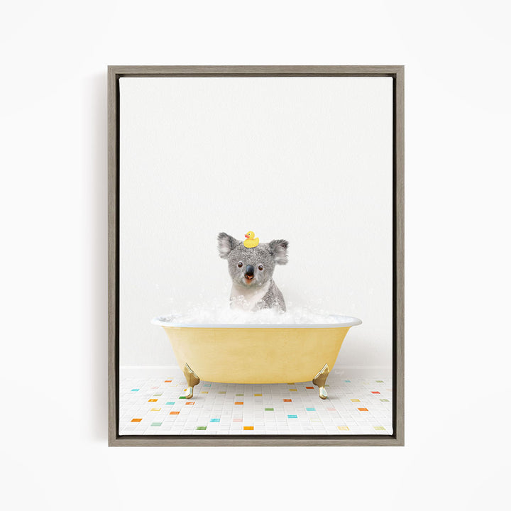 A koala bear sitting in a yellow bathtub filled with bubbles, wearing a yellow rubber duck hat.