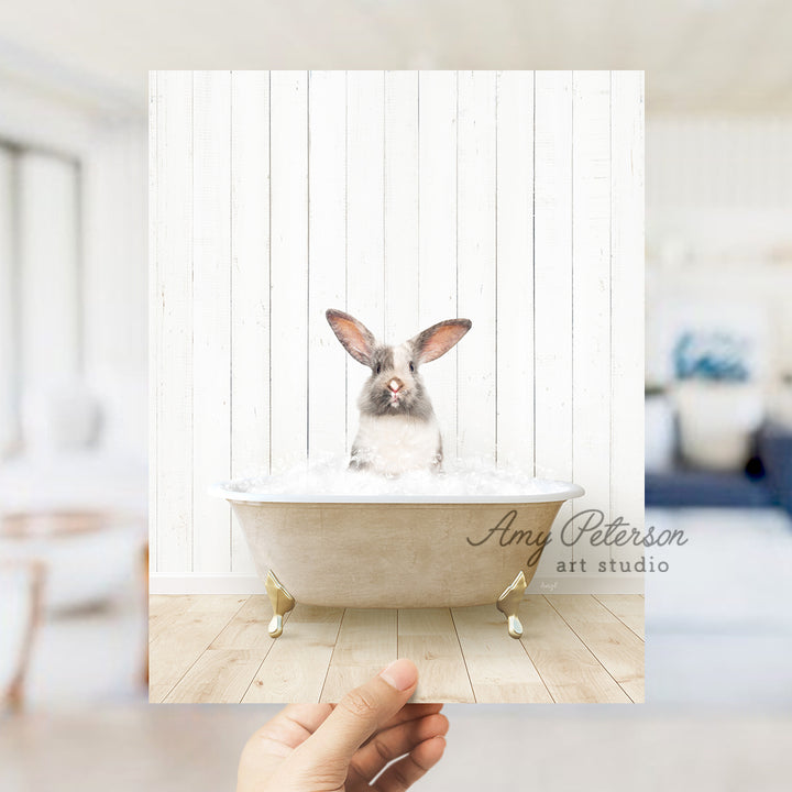 a rabbit sitting in a bathtub with foam on it