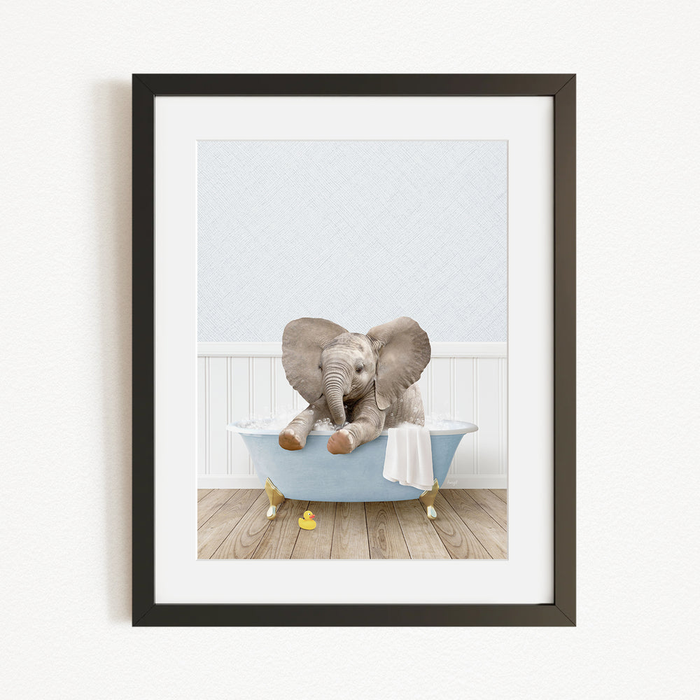 A baby elephant sitting in a blue bathtub, surrounded by yellow rubber duckies, in a white-walled room.
