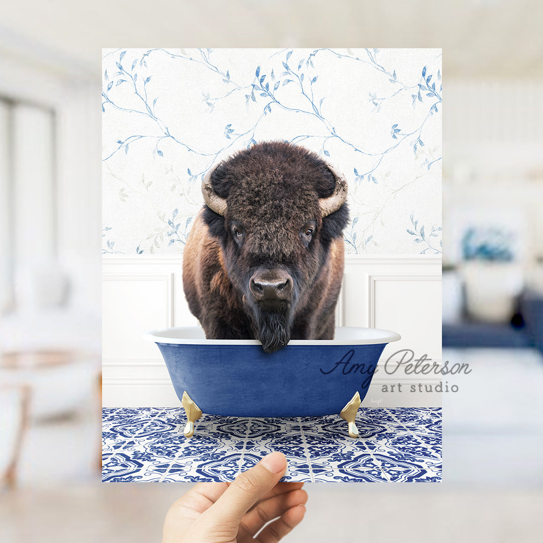 a bison in a bath tub with a hand holding it