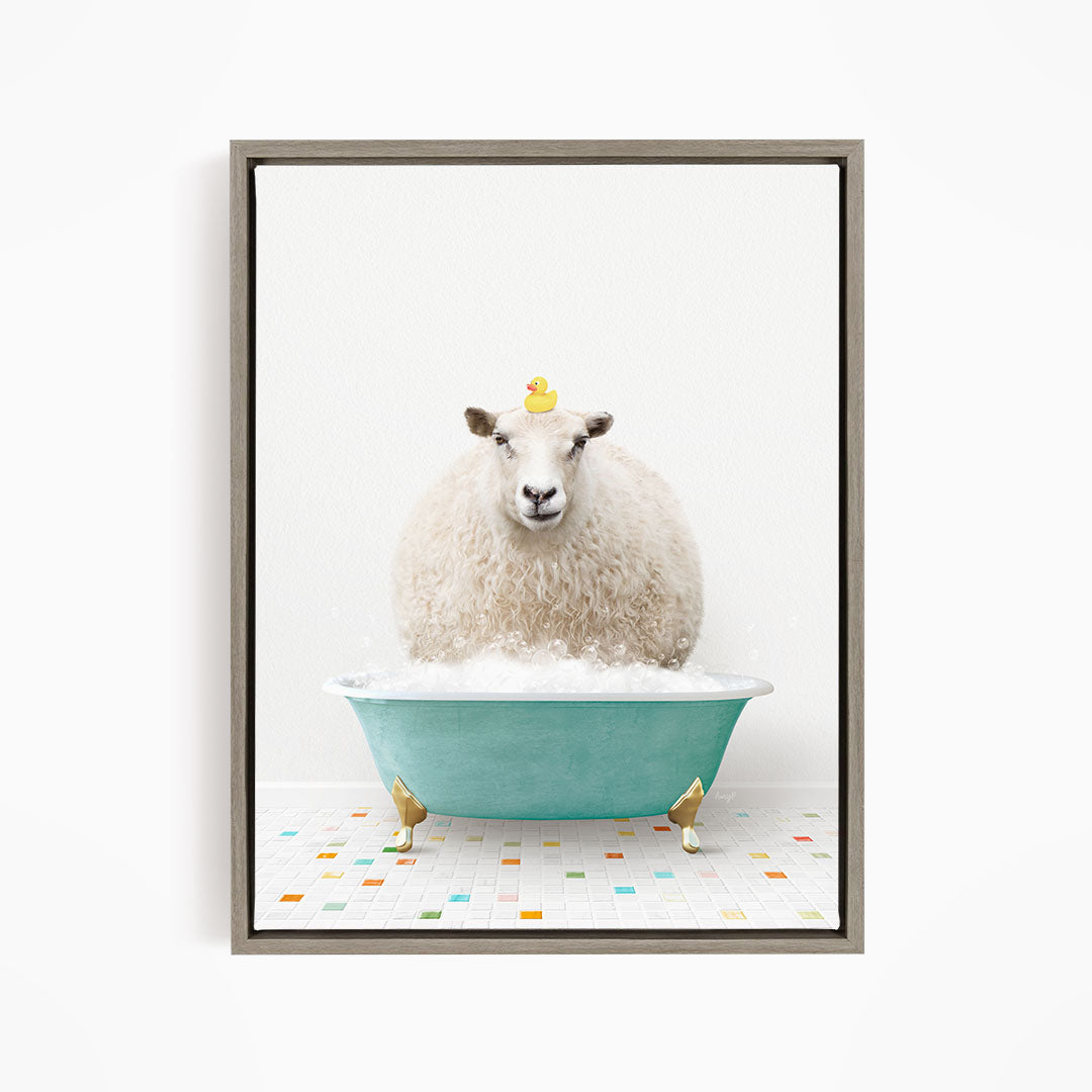 A fluffy white sheep sits in a blue bathtub filled with bubbles, with a yellow rubber duck perched on its head.