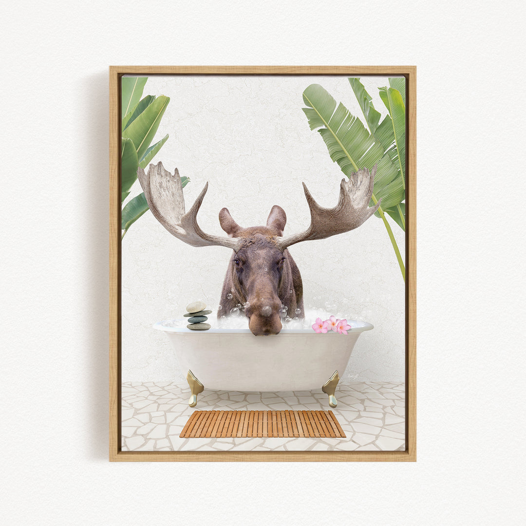 A moose with large antlers is sitting in a bathtub filled with water, surrounded by tropical plants and flowers.