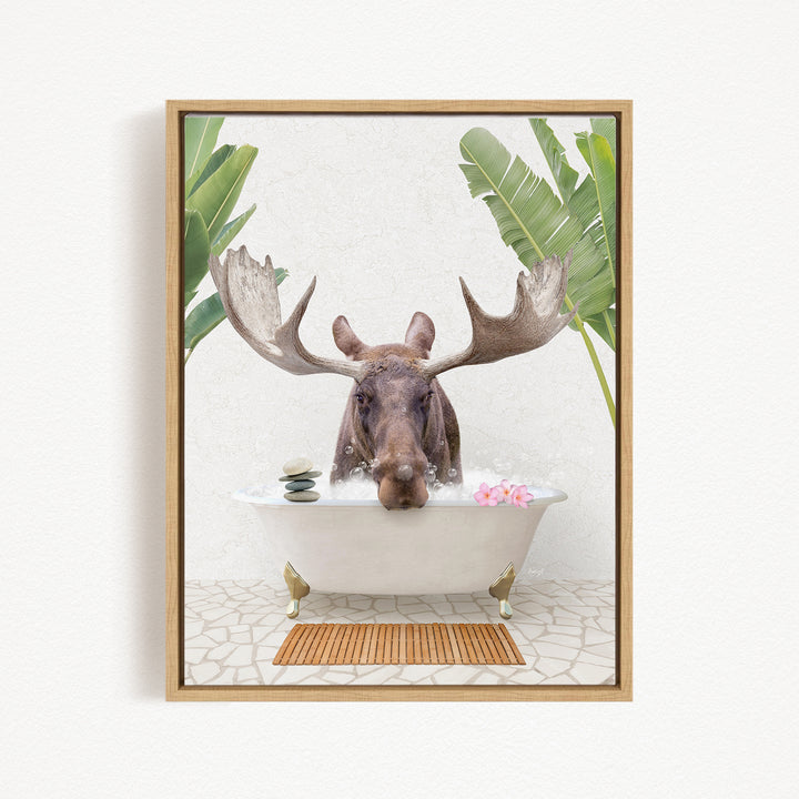 A moose with large antlers is sitting in a bathtub filled with water, surrounded by tropical plants and flowers.