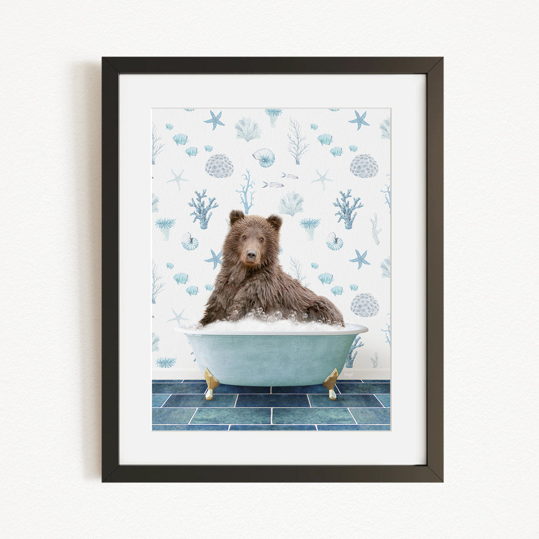 A brown bear sitting in a bathtub filled with bubbles, surrounded by a blue and white ocean-themed wallpaper.