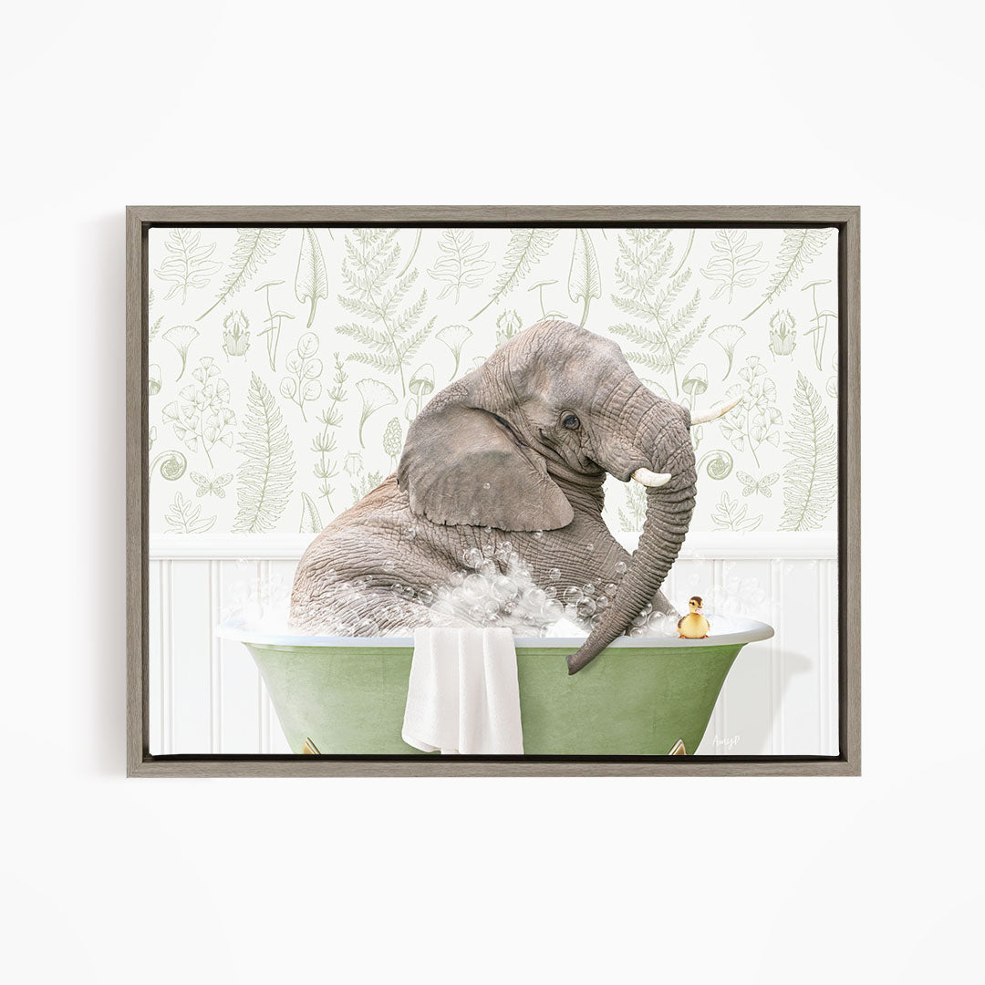 A gray elephant is sitting in a green bathtub, surrounded by bubbles, with a small yellow duck nearby.