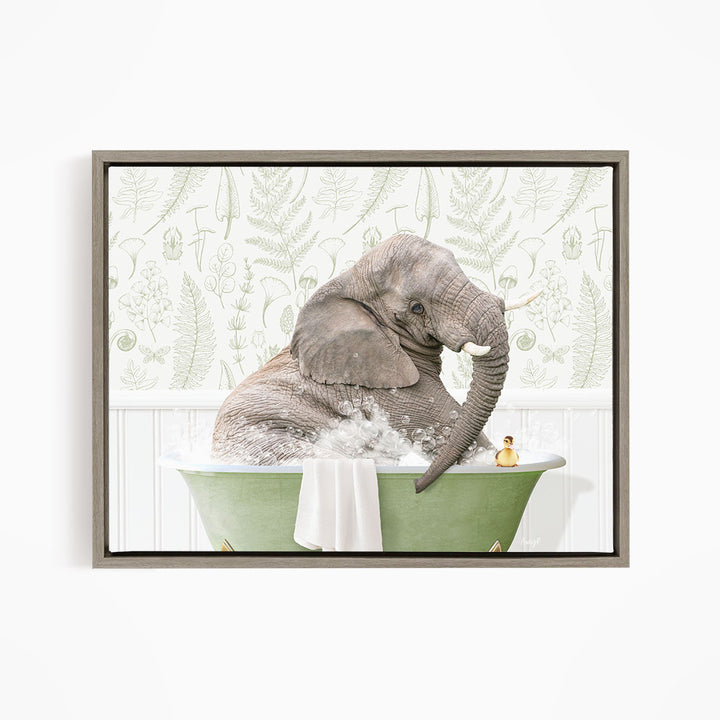 A gray elephant is sitting in a green bathtub, surrounded by bubbles, with a small yellow duck nearby.