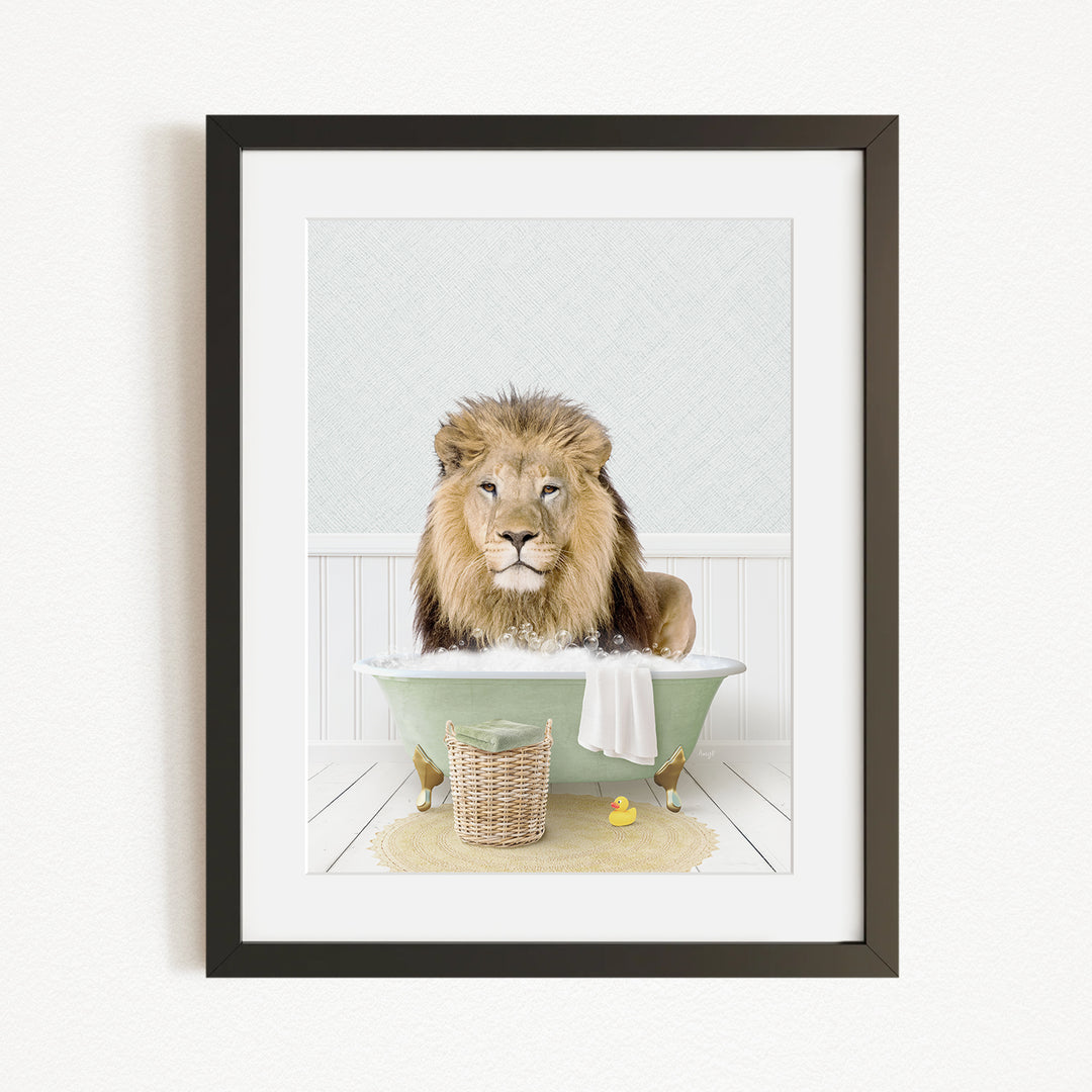 A lion sitting in a green bathtub, surrounded by a basket of rubber ducks and a towel.