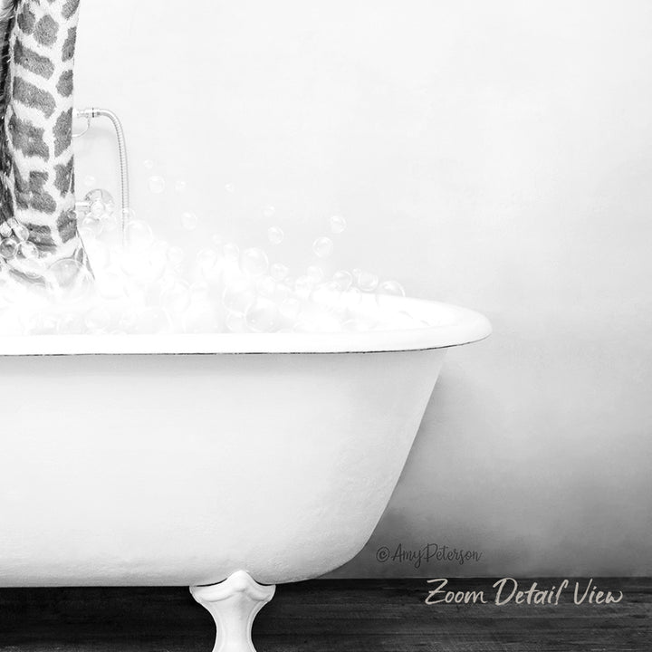 A white claw-foot bathtub filled with soapy water, with a shower curtain hanging nearby.