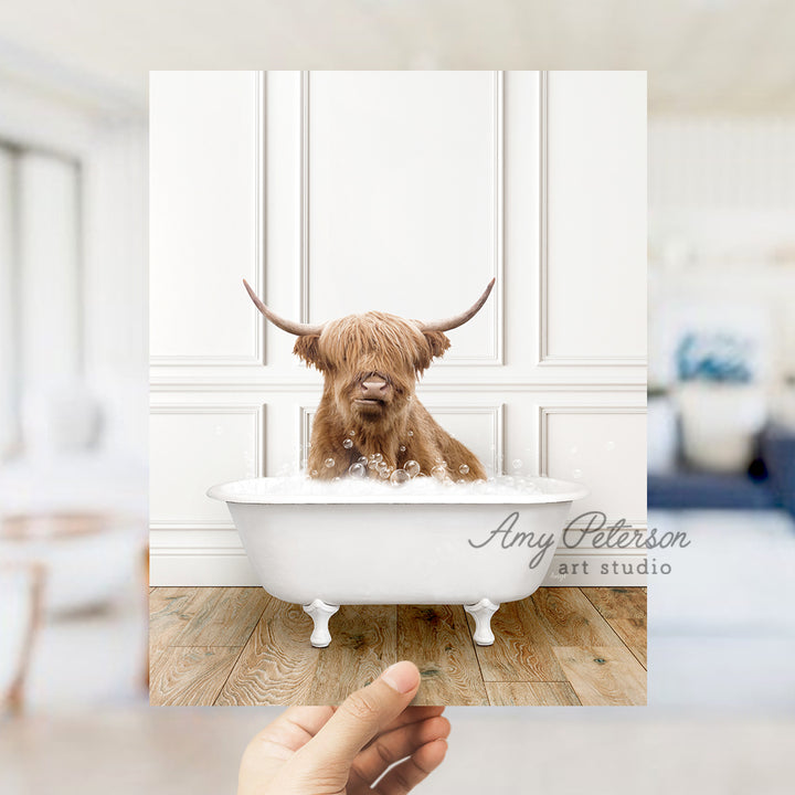 a hand holding a photo of a dog in a bathtub