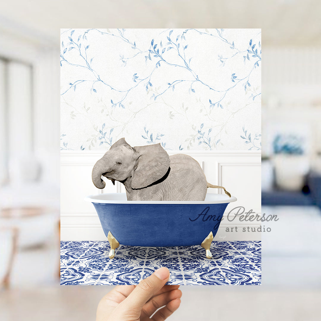 a hand holding a card with an elephant in a bathtub