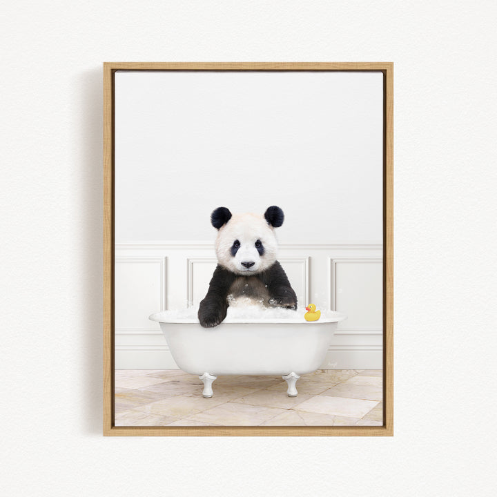 A panda bear sitting in a white bathtub, surrounded by a yellow rubber duck.