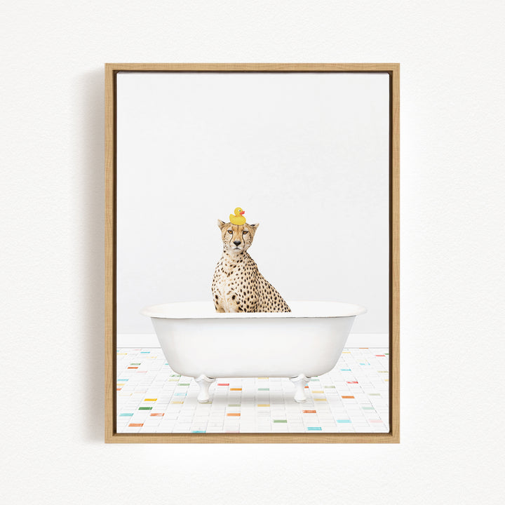 A cheetah wearing a yellow rubber duck hat sits in a white bathtub, surrounded by a colorful tiled floor.