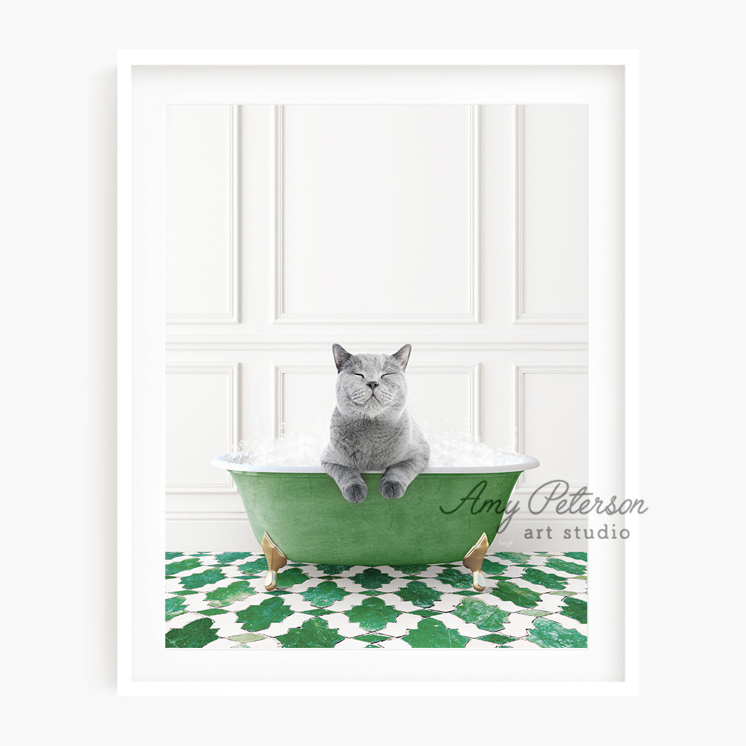 a gray cat sitting in a green bath tub