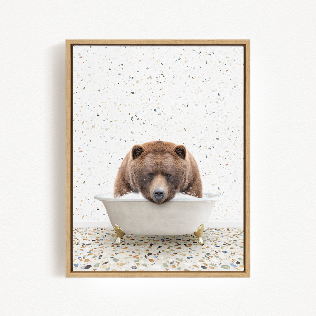 A brown bear is sitting in a white bathtub, appearing to be enjoying a relaxing bath.