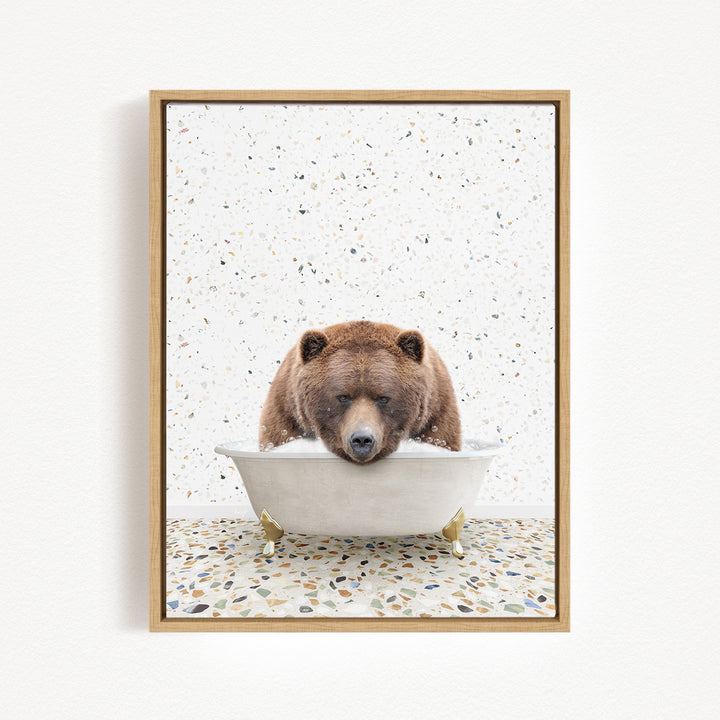 A brown bear is sitting in a white bathtub, appearing to be enjoying a relaxing bath.