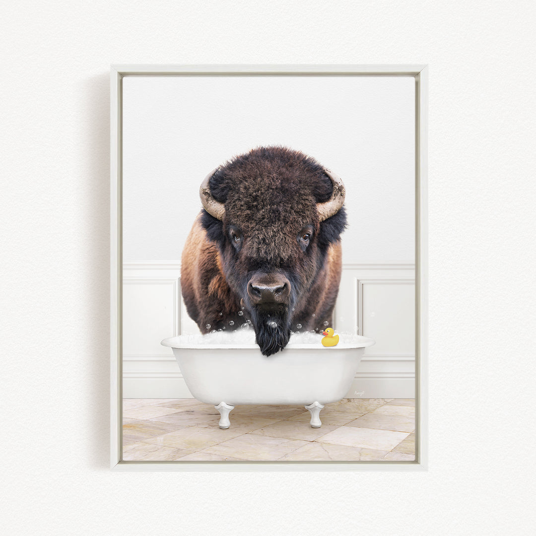 A buffalo with a long beard is standing in a white bathtub, with a rubber duck floating in the water.