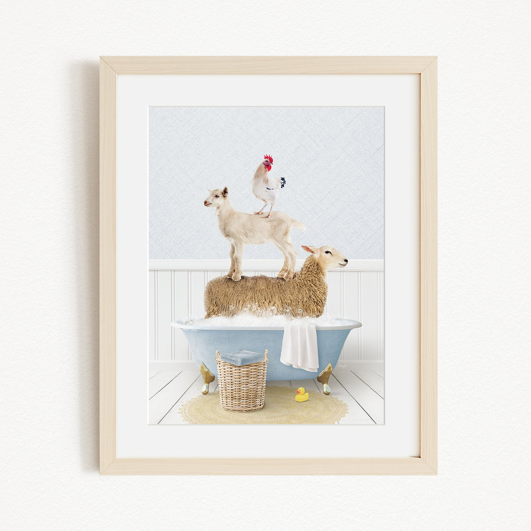 A framed image depicting a goat standing on top of a sheep in a bathtub, with a rooster perched on the sheep's back.