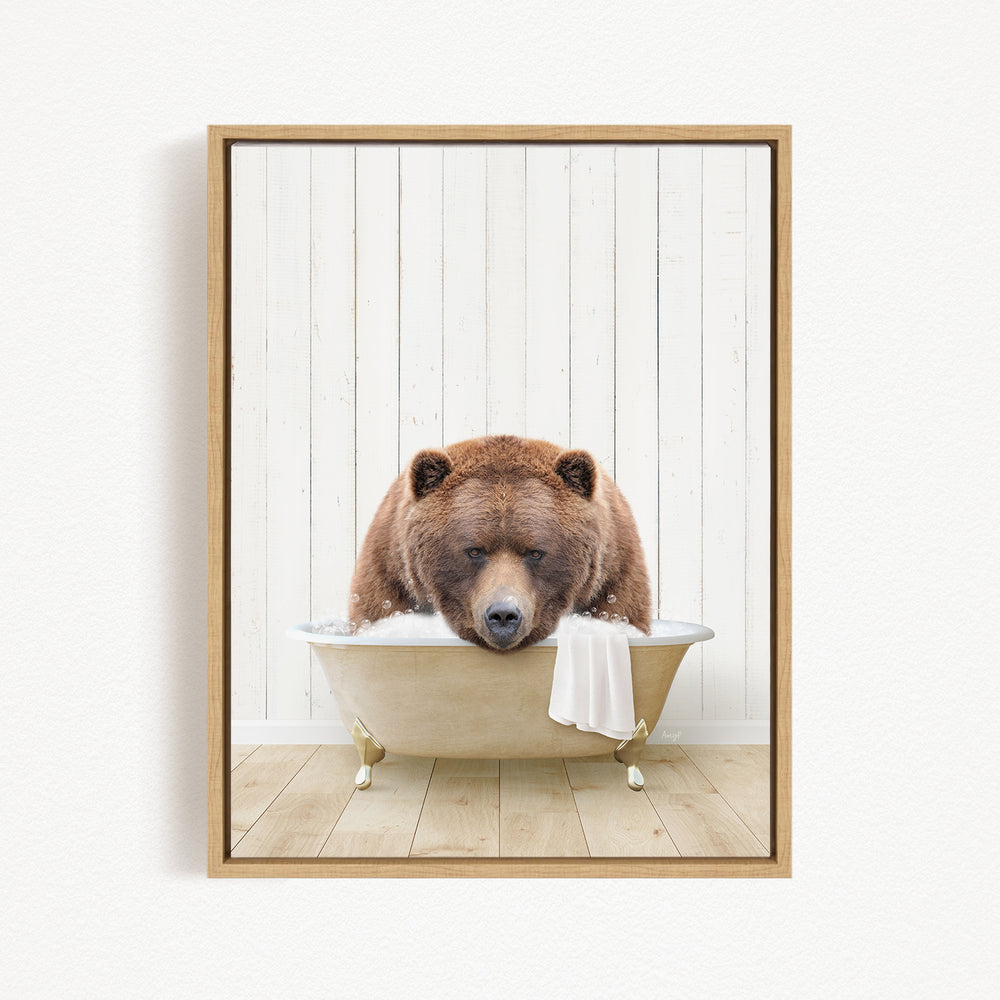 A brown bear sitting in a bathtub filled with water, with a towel hanging from the tub.