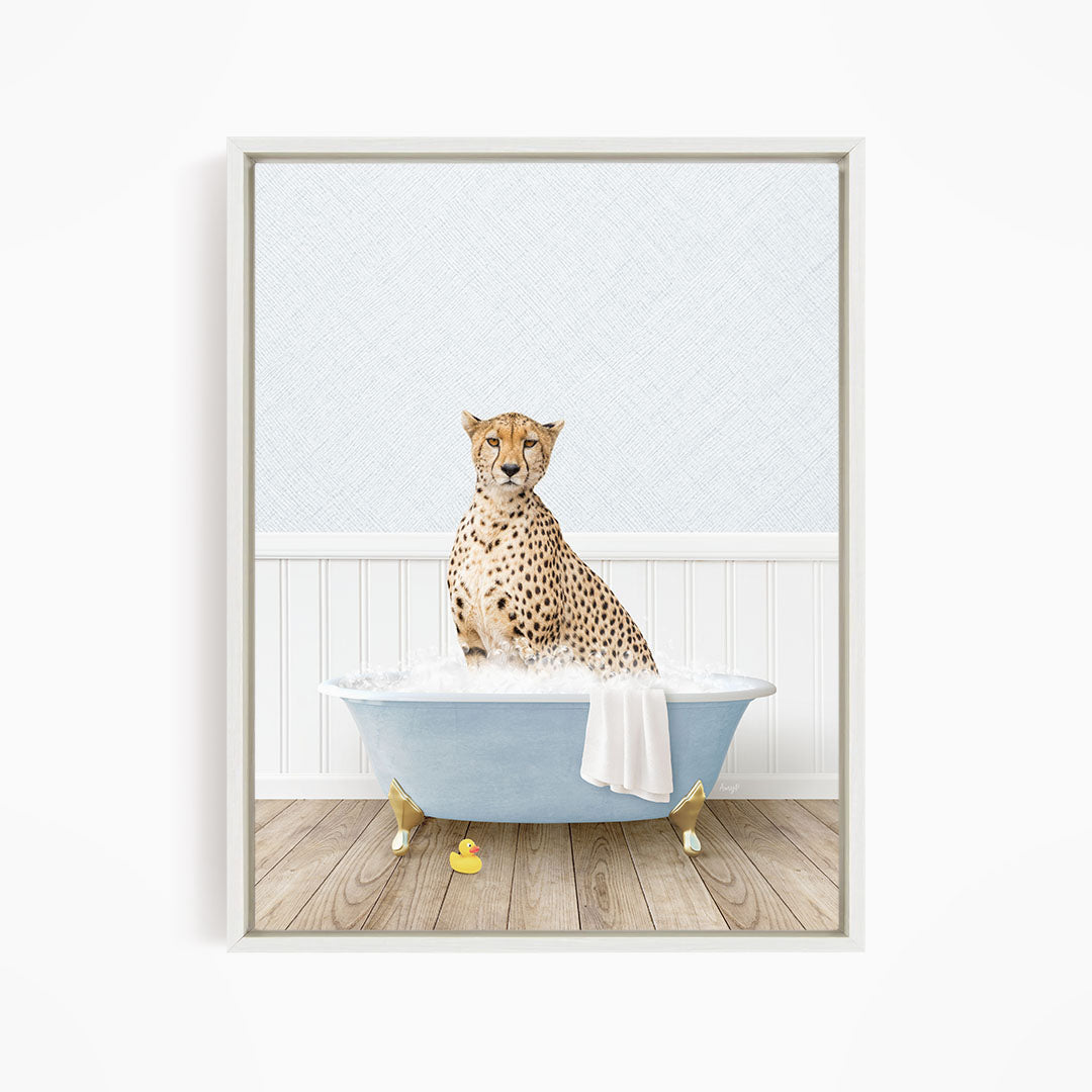A cheetah sits in a blue bathtub filled with water, surrounded by rubber ducks.