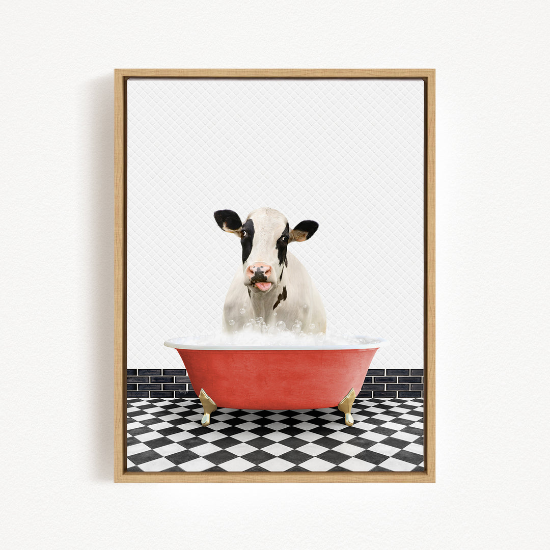 A black and white cow is sitting in a red bathtub filled with water, creating a whimsical and humorous scene.