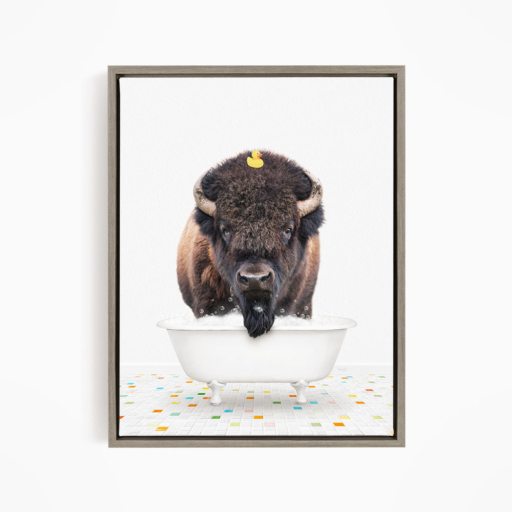 A buffalo standing in a white bathtub, with a yellow rubber duck on its head.