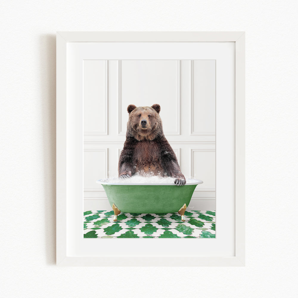 A brown bear sitting in a green bathtub filled with water, surrounded by a green and white patterned rug.