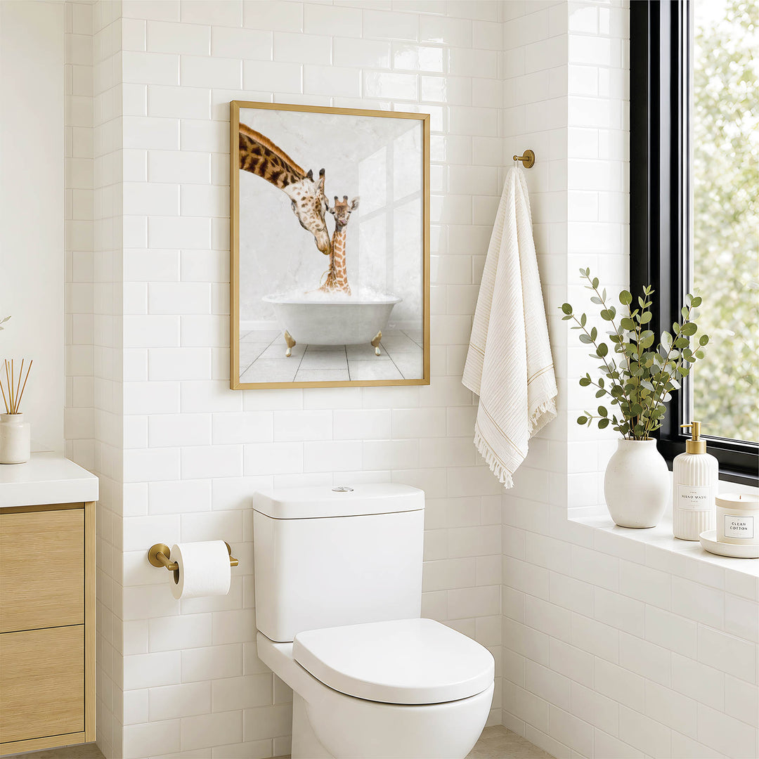 A bathroom with a white toilet, a framed picture of a giraffe in a bathtub, and a window with greenery on the sill.