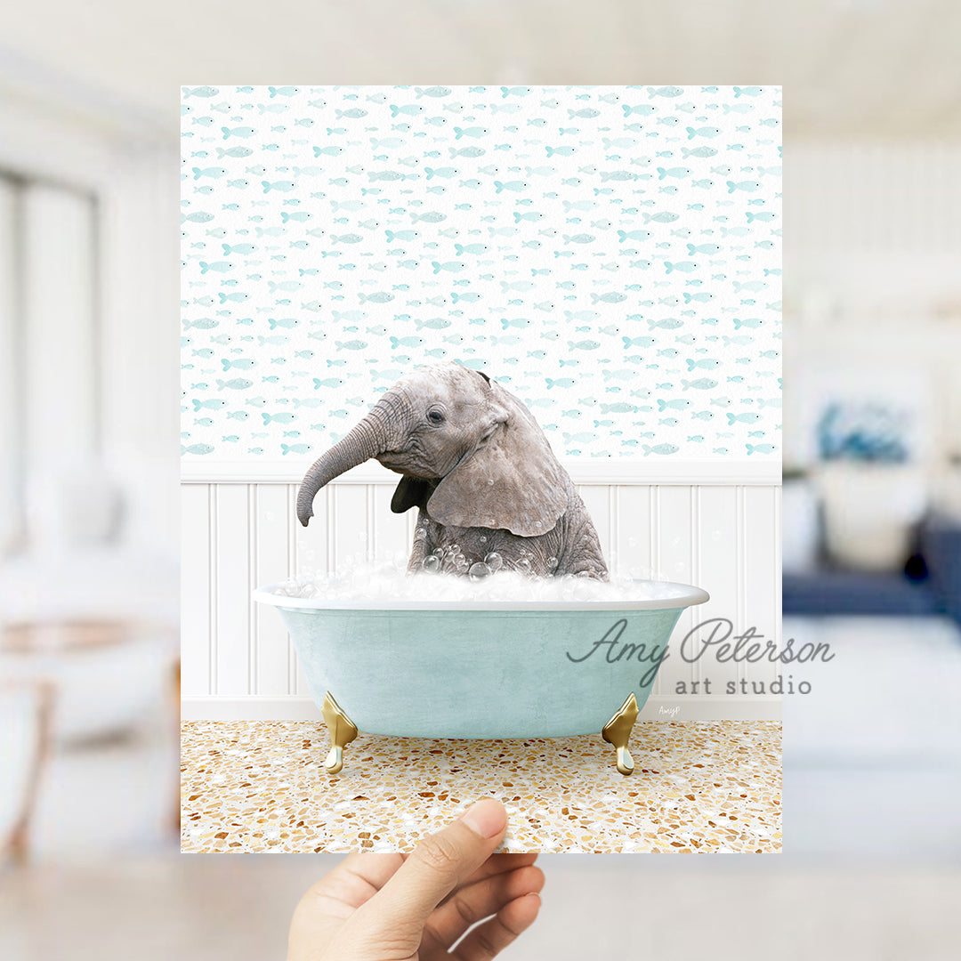 a person holding up a picture of an elephant in a bathtub