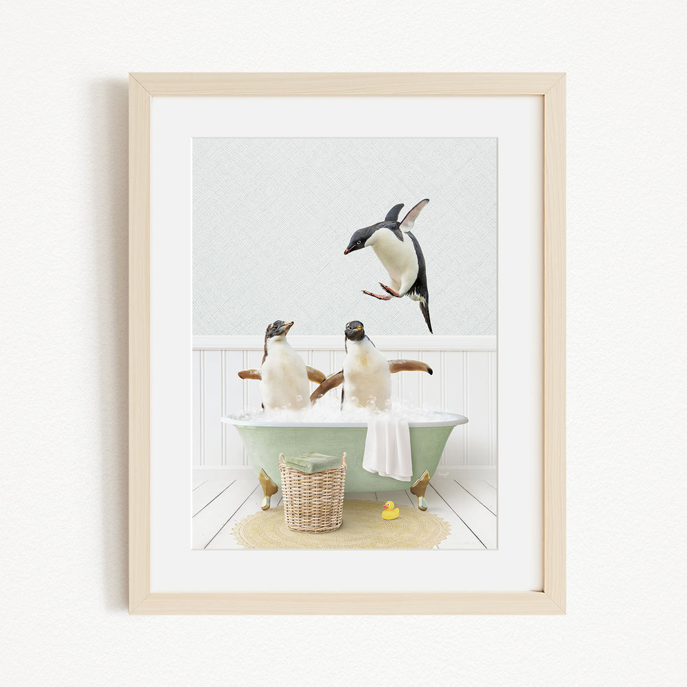 A framed image depicting two penguins sitting in a bathtub, with one penguin flying towards the other penguin.