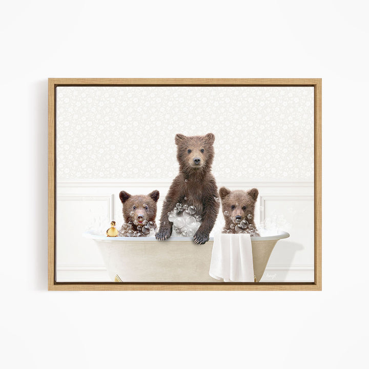A framed image depicting three bears sitting in a bathtub, with one bear sitting on the edge of the tub and the other two bears sitting inside the tub.
