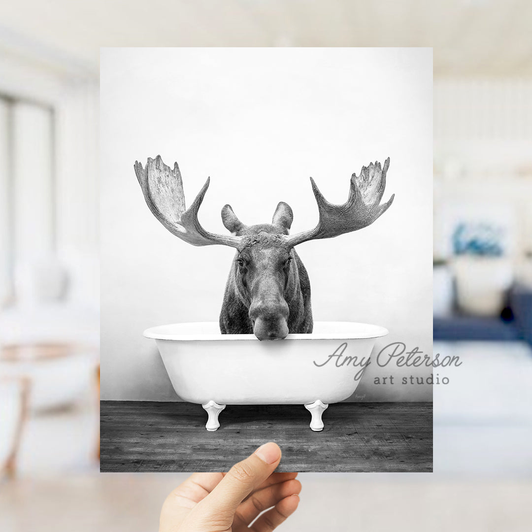 a person holding up a card with a picture of a moose in a bathtub