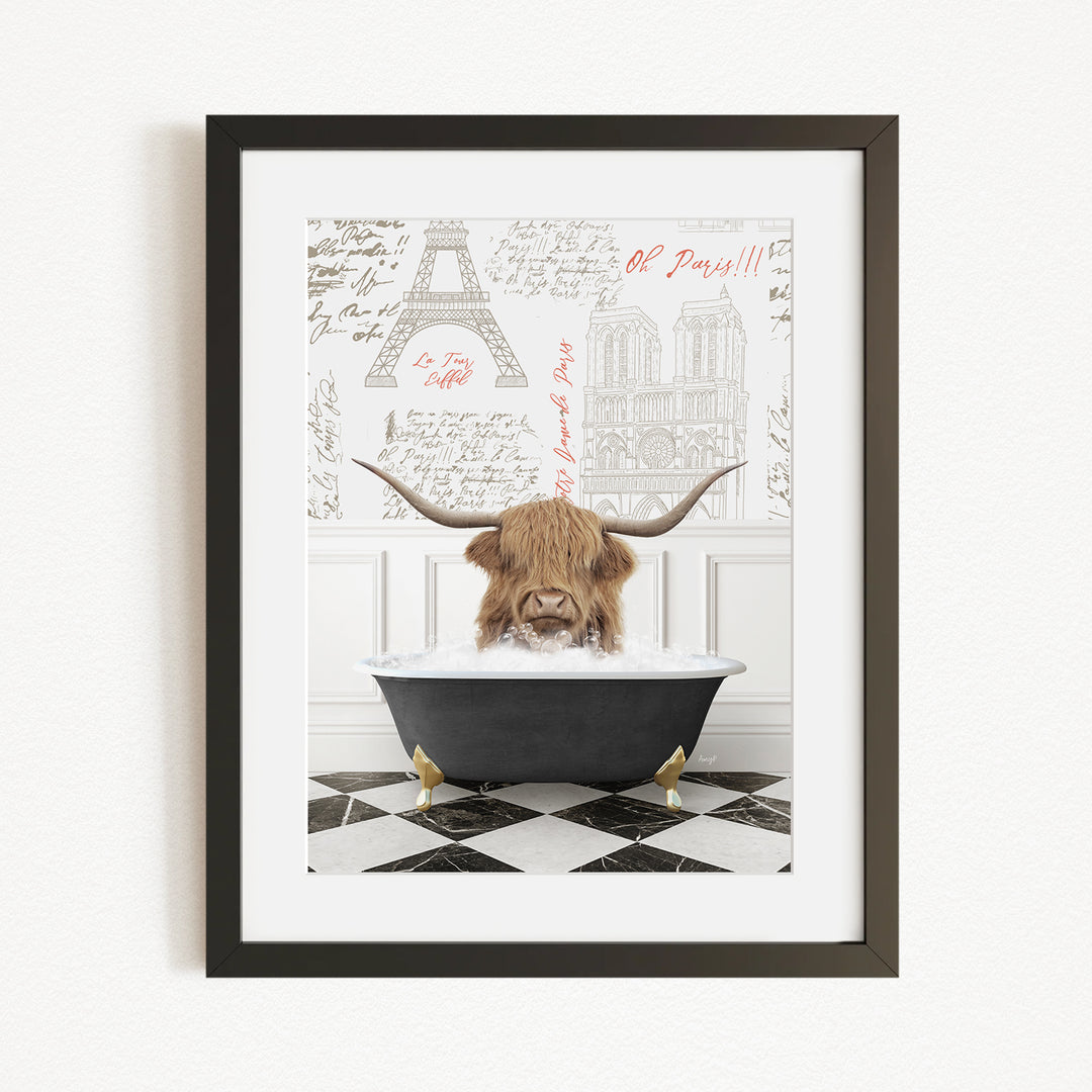 A framed image depicting a long-haired, horned animal, possibly a yak or a yak dog, sitting in a bathtub filled with water, with a drawing of the Eiffel Tower in the background.