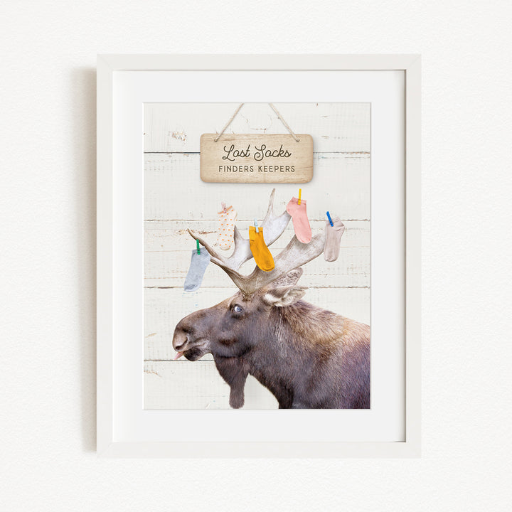 A framed image of a moose with a sign above it that says "Red Socks Finders Keepers".