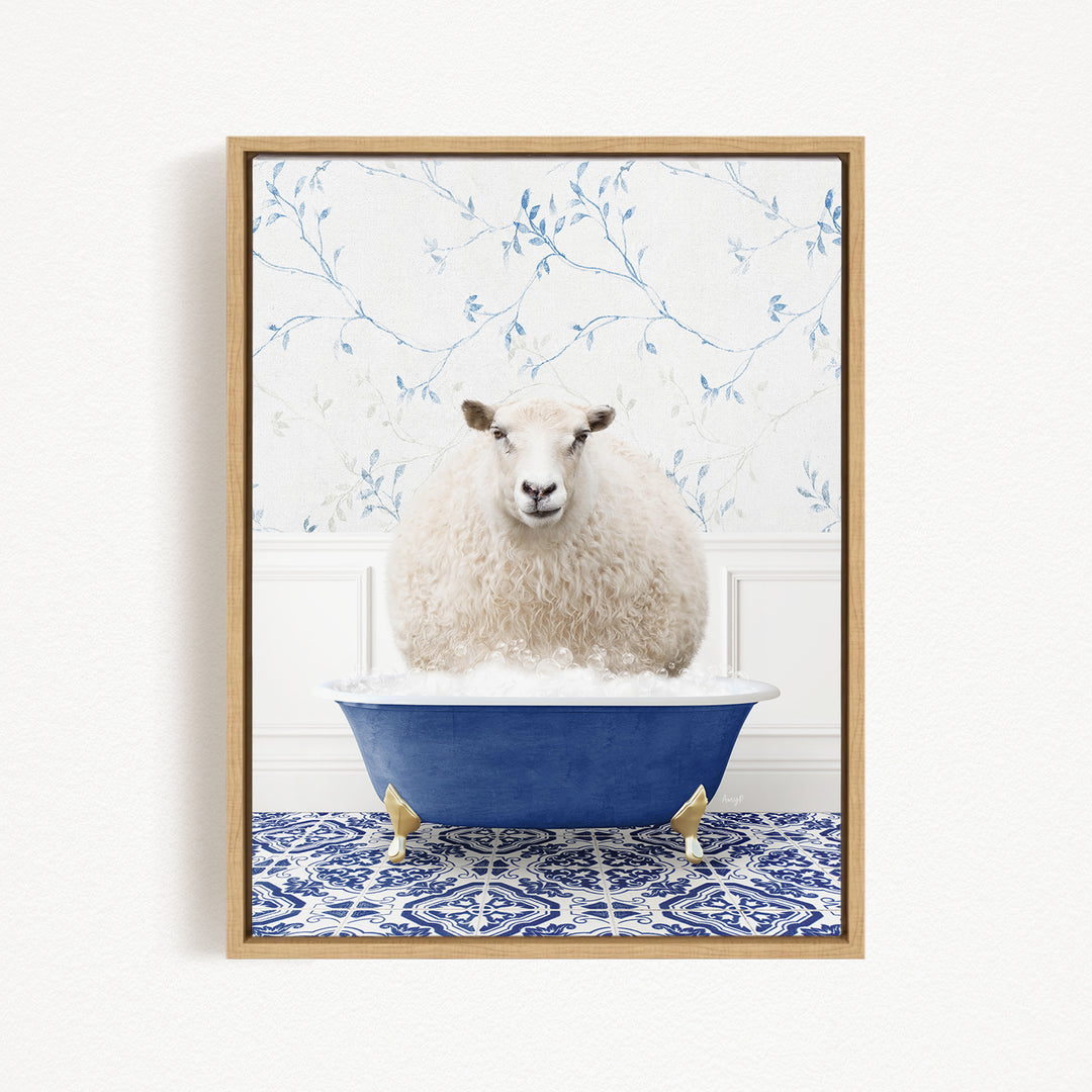 A fluffy white sheep sits in a blue bathtub, surrounded by a blue and white patterned rug and a floral wallpaper background.