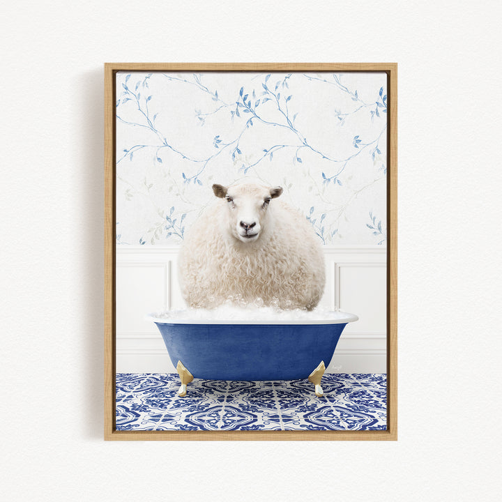 A fluffy white sheep sits in a blue bathtub, surrounded by a blue and white patterned rug and a floral wallpaper background.