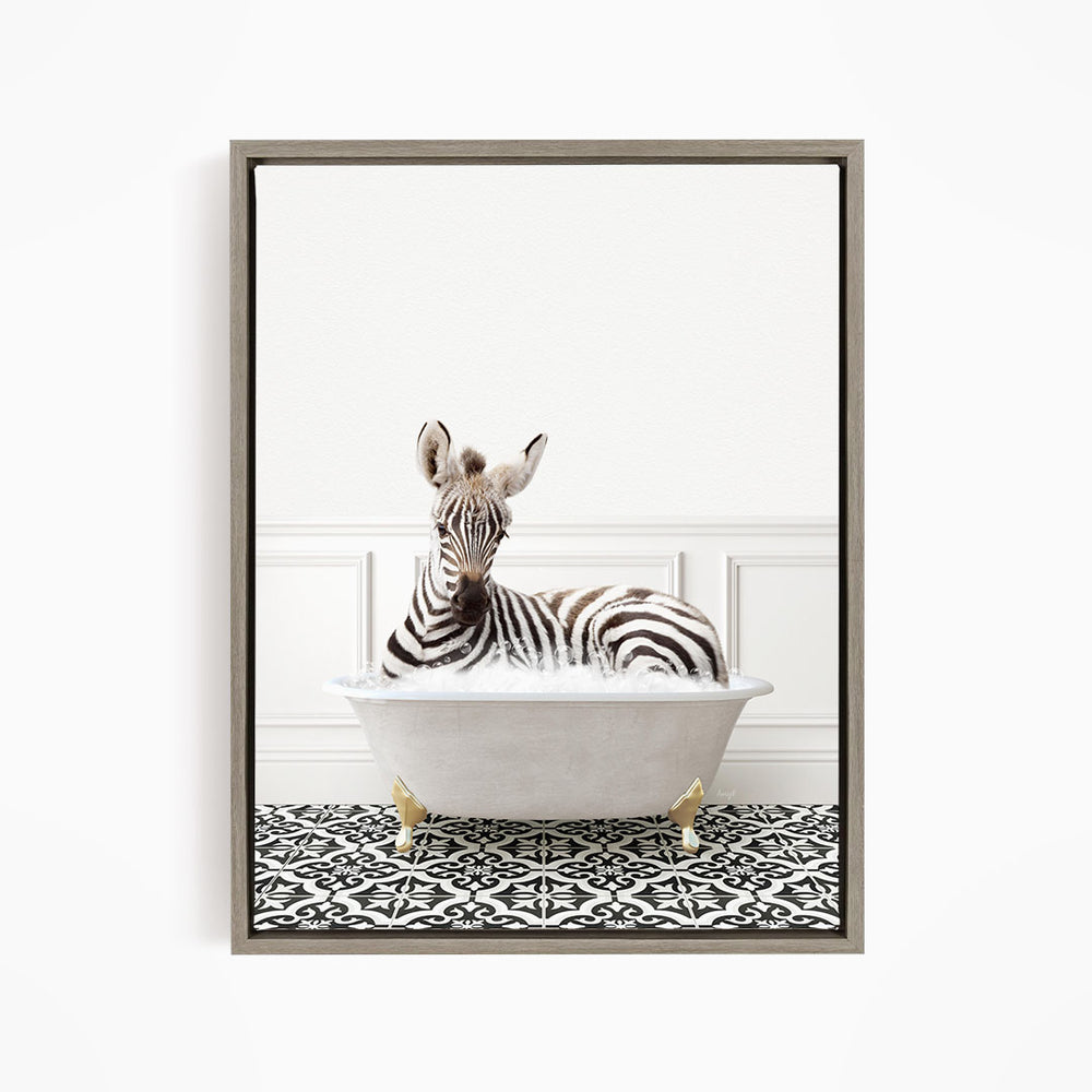 A zebra is sitting in a white bathtub with gold legs, resting on a black and white patterned floor.