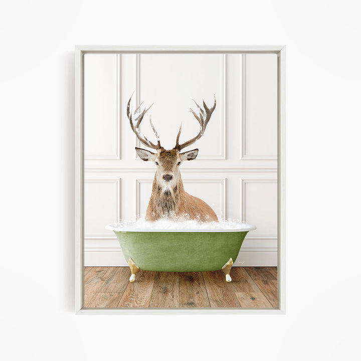 A deer with large antlers is sitting in a green bathtub, surrounded by bubbles.