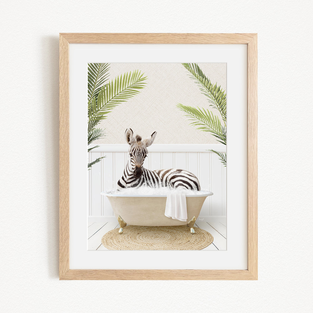 A zebra is sitting in a bathtub, surrounded by palm leaves, creating a whimsical and playful scene.