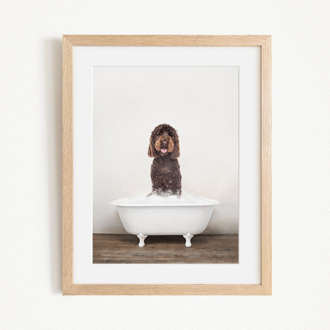 A brown dog sitting in a white bathtub filled with water, with bubbles around it, and the dog appears to be enjoying the bath.