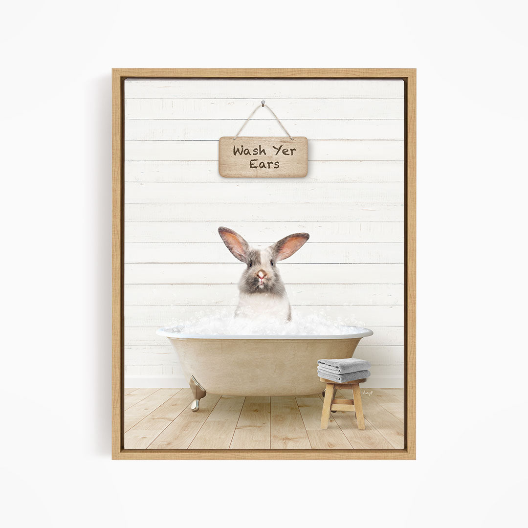 A white rabbit sitting in a bathtub, with a wooden sign above that says "Wash Your Ears".