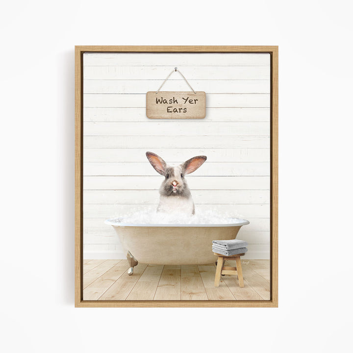 A white rabbit sitting in a bathtub, with a wooden sign above that says "Wash Your Ears".