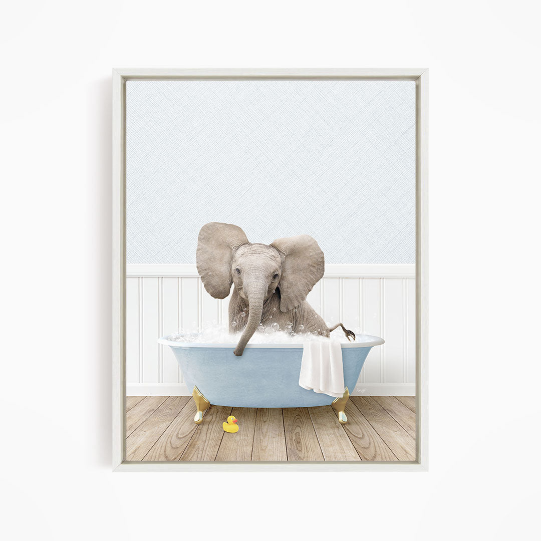 A baby elephant sitting in a blue bathtub filled with water, surrounded by rubber duckies.