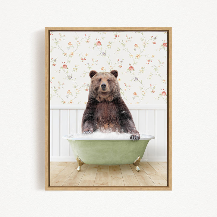 A brown bear sitting in a green bathtub filled with water, surrounded by a floral wallpaper.