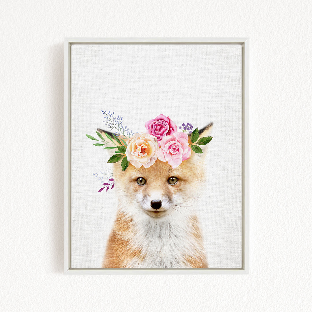 A fox wearing a floral crown on its head, with pink and white flowers and green leaves adorning its head.