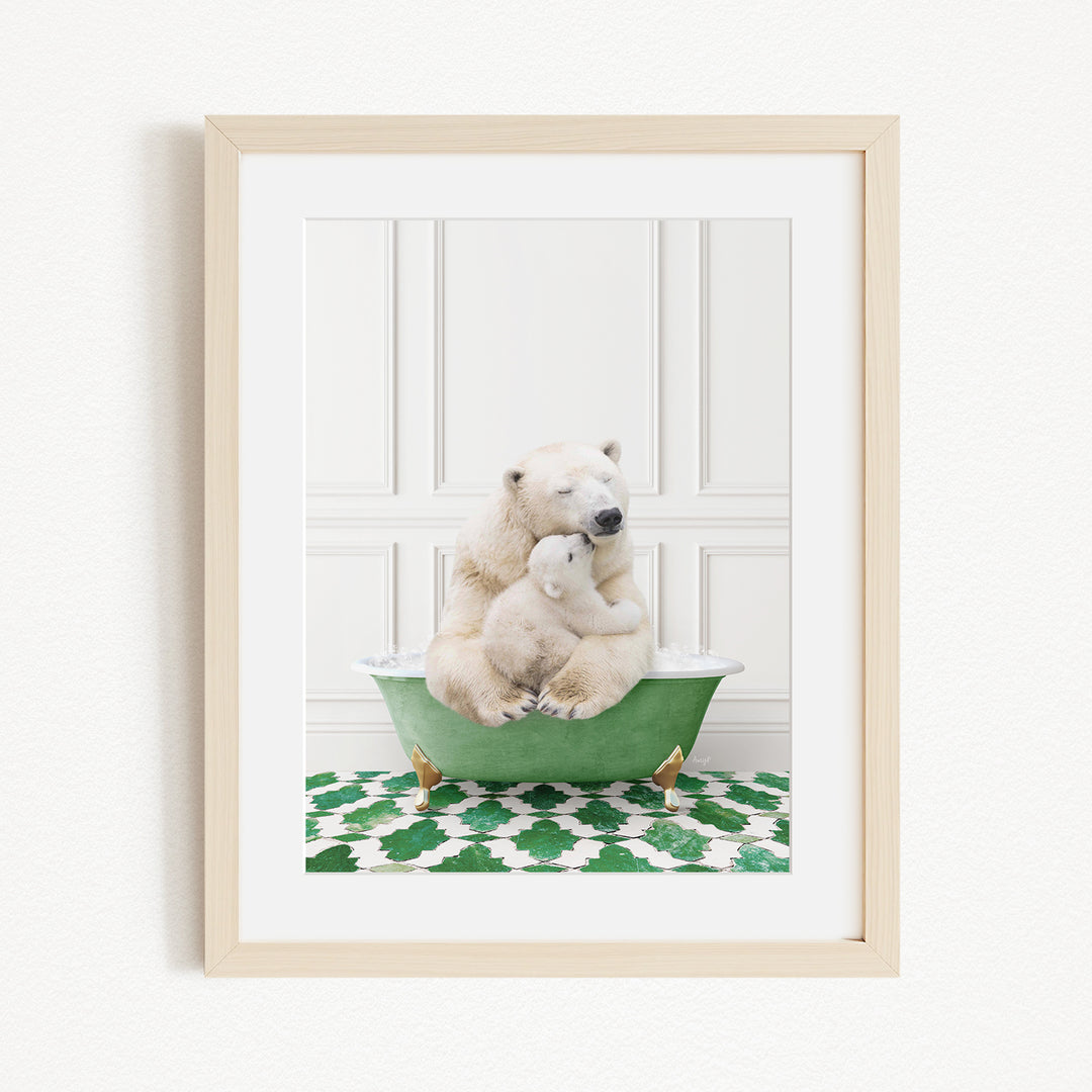 A framed image depicting a mother polar bear sitting in a green bathtub, with her cub resting on her lap, against a white wall with a green and white patterned rug.