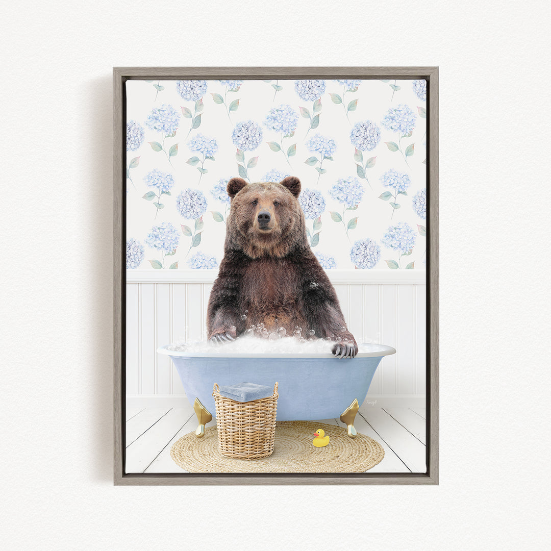 A brown bear sitting in a blue bathtub filled with water, surrounded by a wicker basket and a rubber duck.