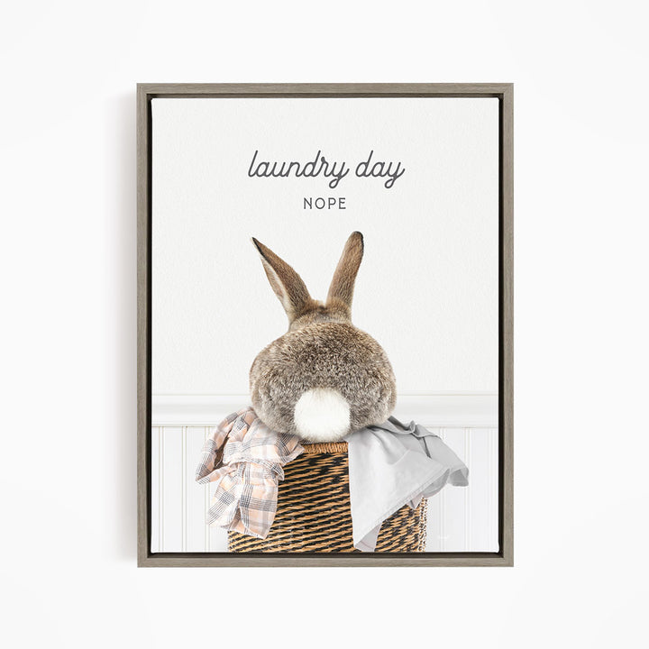 A cute rabbit sitting in a laundry basket, with the text "laundry day NOPE" above it.