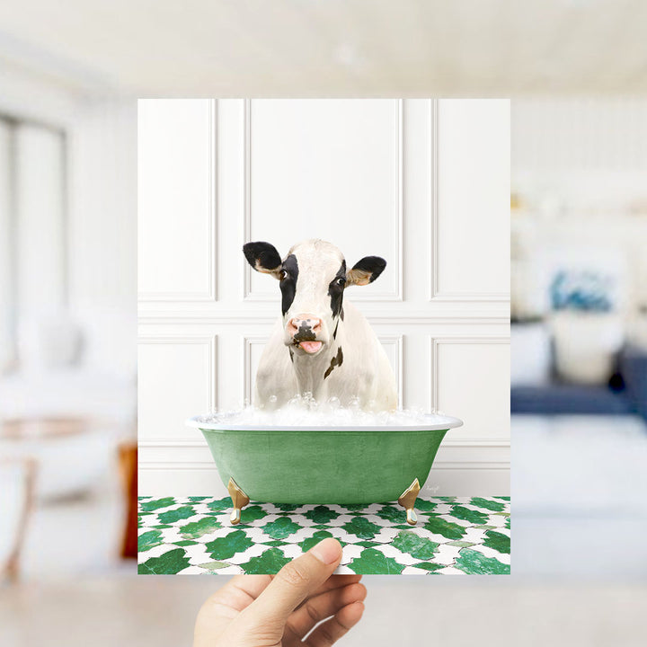 A cow is sitting in a green bathtub filled with water, with its head poking out of the tub.