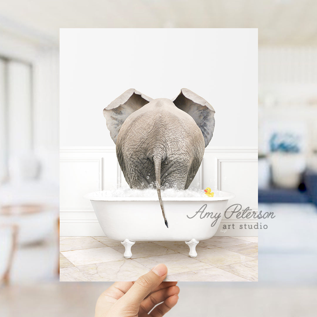 a person holding up a card with an elephant in a bathtub